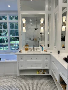 Modern white floating vanity with sink drawers, custom-built in Greensboro home.
