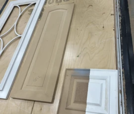 Raised panel cabinet door displayed beside a cabinet door corner sample showing unfinished and primed profile details crafted by Borough Wood Works.