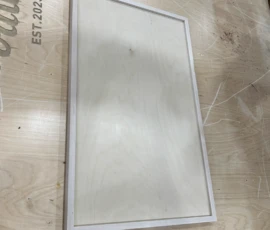 Custom slab cabinet door with a solid wood frame and flat recessed panel, manufactured by Borough Woodworks for modern and transitional cabinetry.