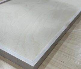 Close-up of a custom slab cabinet door highlighting the clean edge profile, wood grain, and precision craftsmanship by Borough Wooworks.